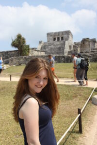 Girl smiles at Tulum Mayan ruins