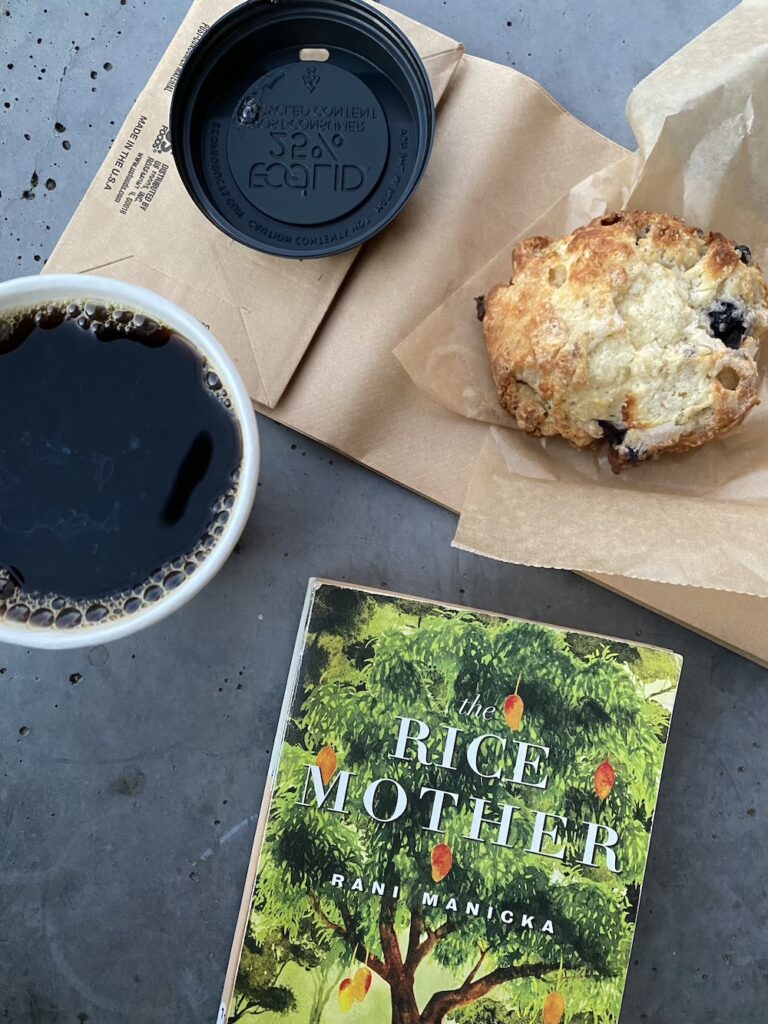 Book on table by scone and coffee